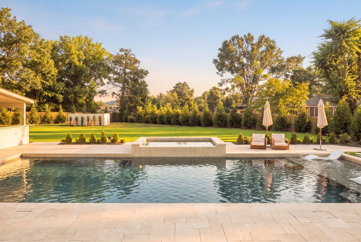 Pool and rear lawn at dusk at a completed Shepherd Group residence